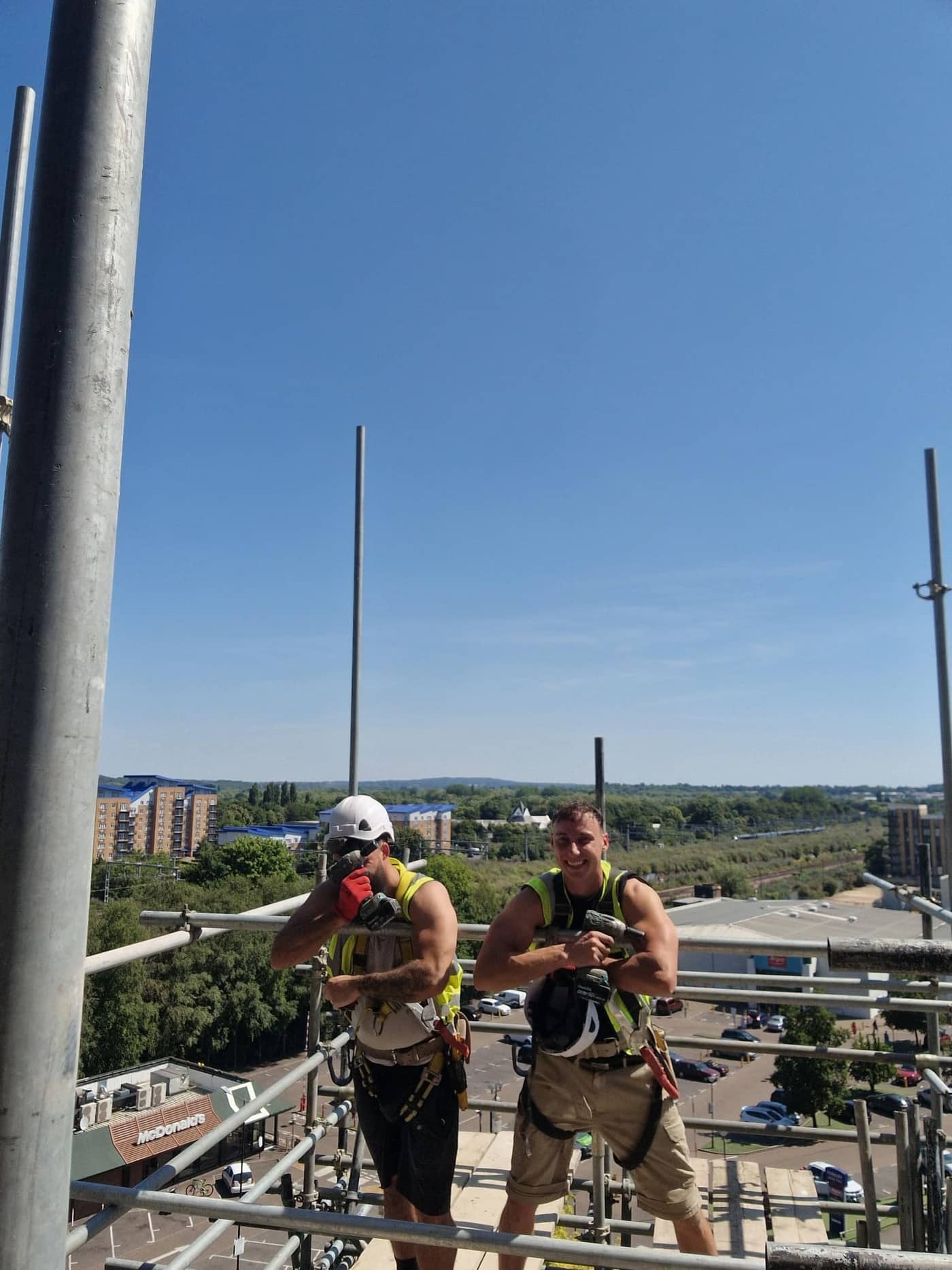 Infinite Scaffolding team members on site in safety harnesses